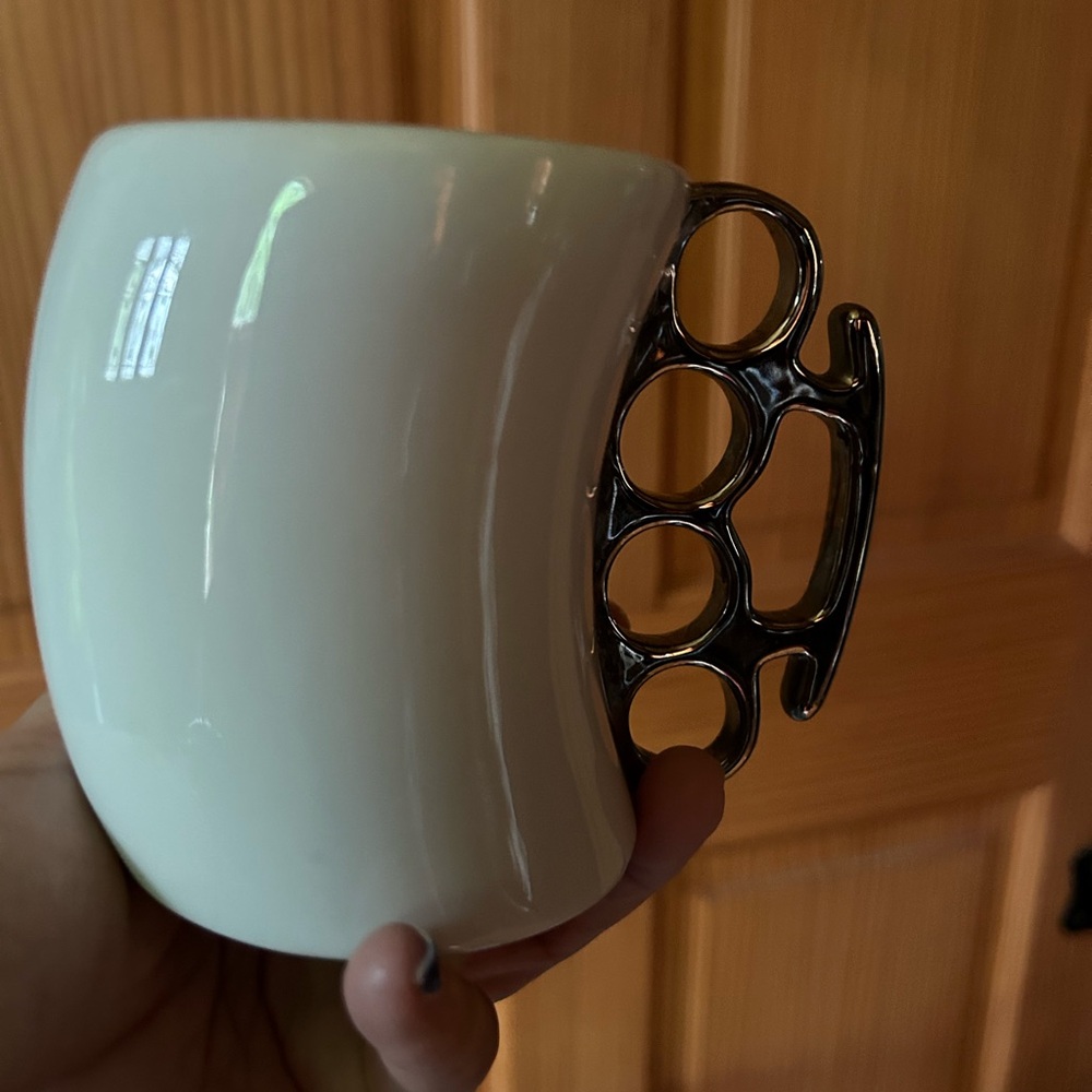 White cup with silver color knuckles